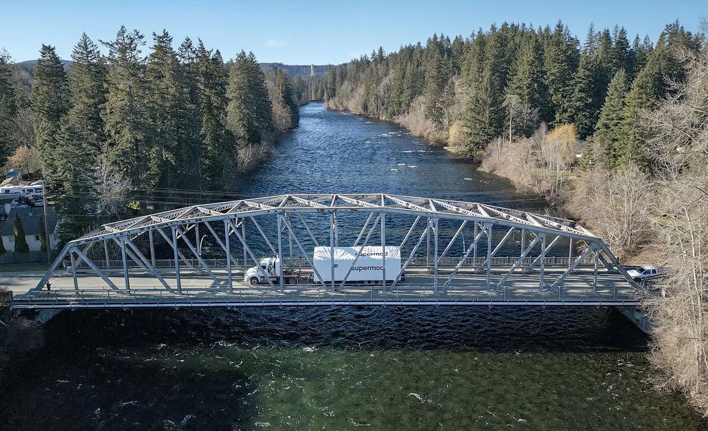 Module truck crossing a steel bridge