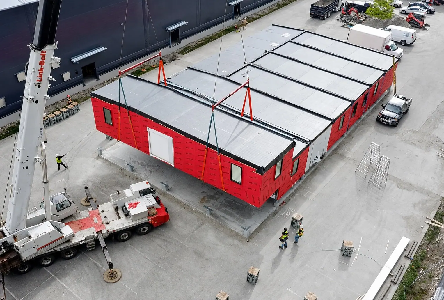 Aerial view of commercial modules set by crane
