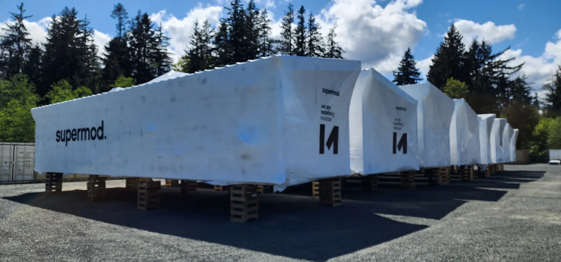 Row of identical completed modules ready for shipment