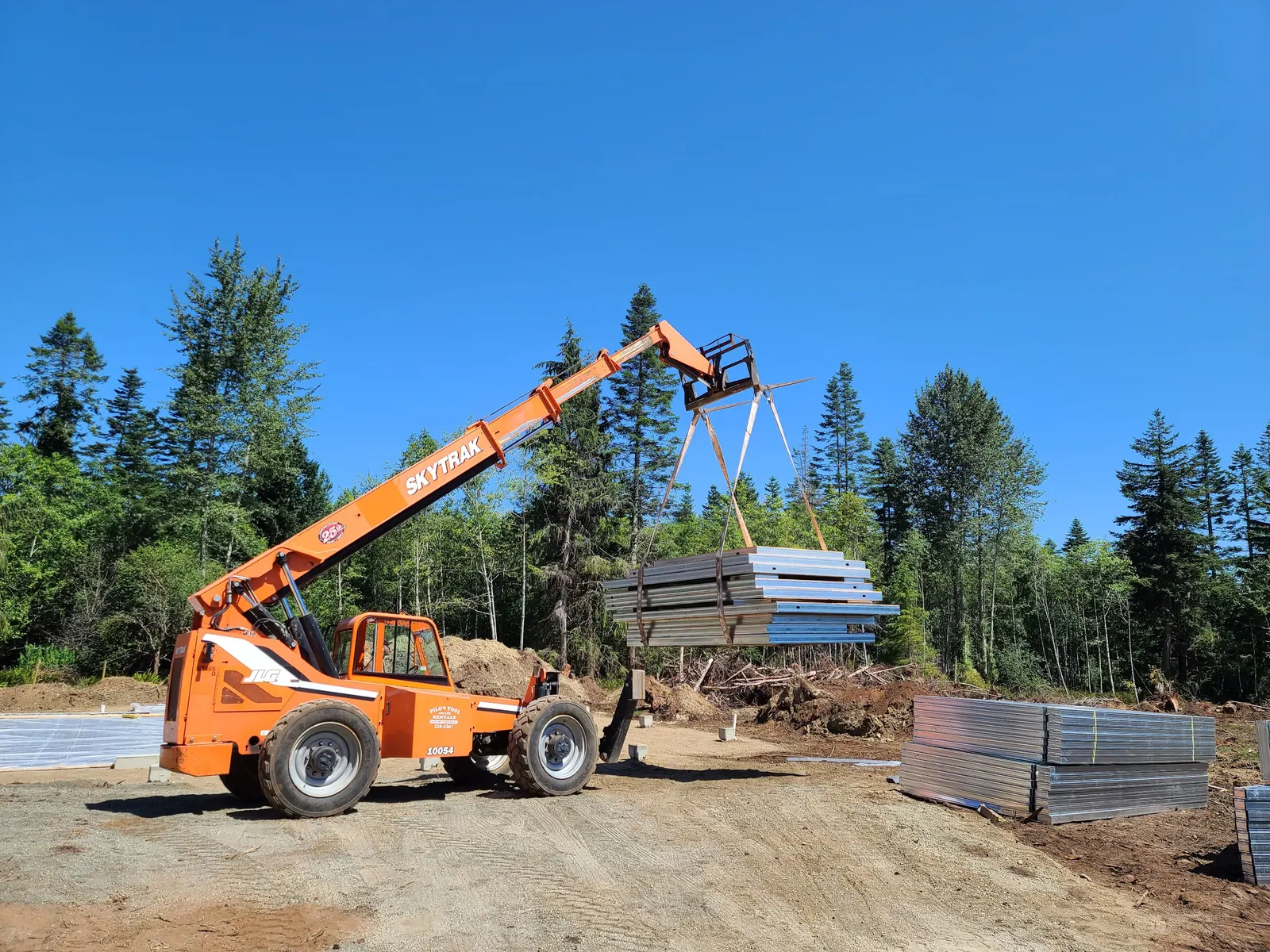Telehandler unloading steel framing bundles on site