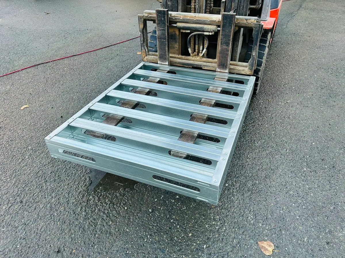 Closed-deck steel pallet on forklift forks