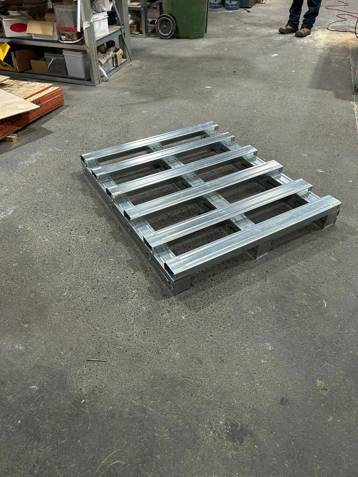 Open-deck steel pallet on the shop floor